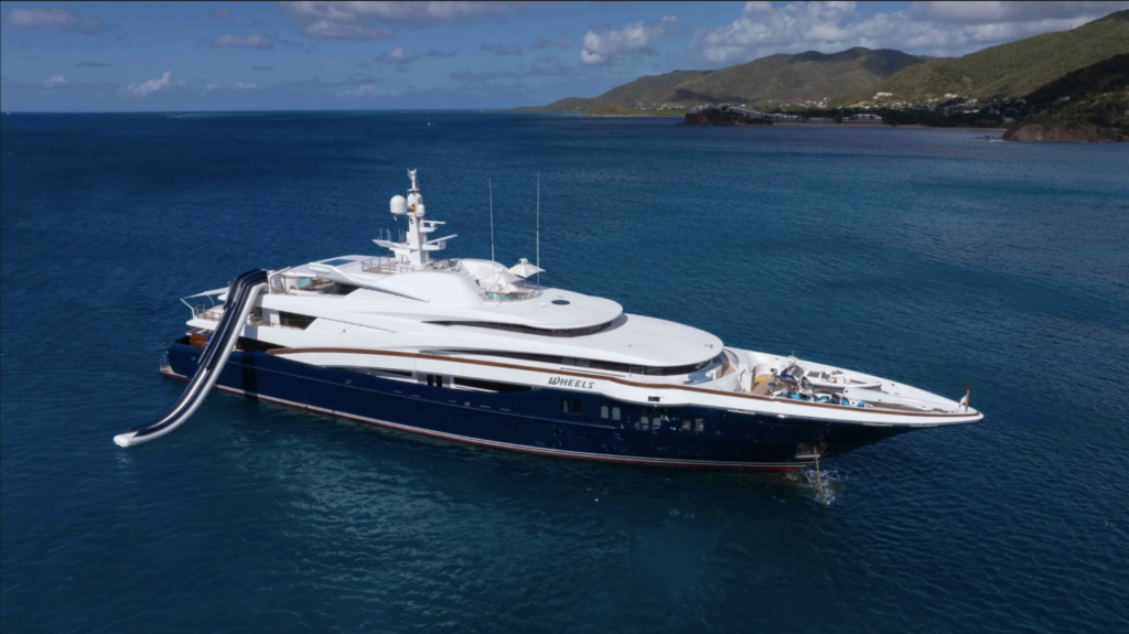 75.5m superyacht WHEELS at anchor with inflatable water slide